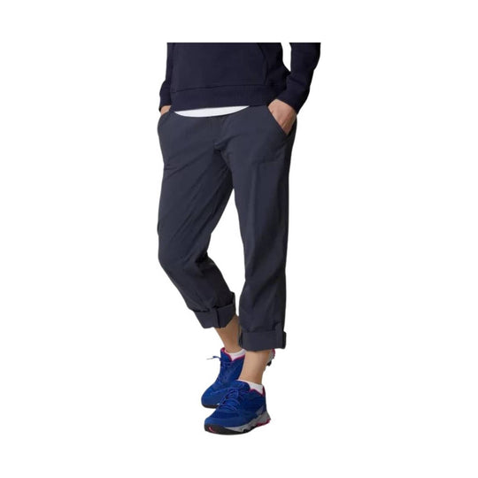 Dark navy cropped trail pants worn with rolled cuffs and side pockets