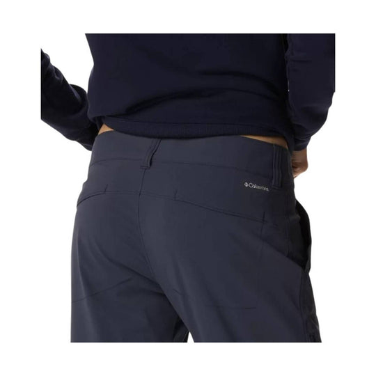 Back view of dark navy hiking pants with a Columbia logo on the right back pocket