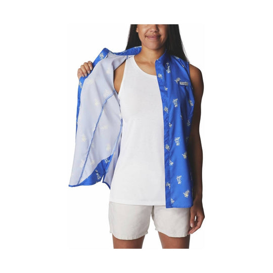 Blue patterned sleeveless button-up shirt worn open over a white tank top