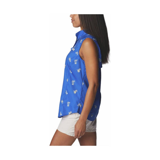 Sleeveless blue patterned button-up shirt worn with white shorts