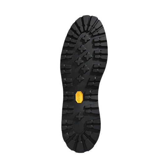 Black lugged boot outsole with a yellow Vibram badge