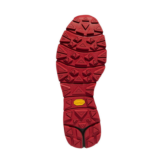 Red hiking boot outsole with deep triangular lugs and a yellow Vibram logo.