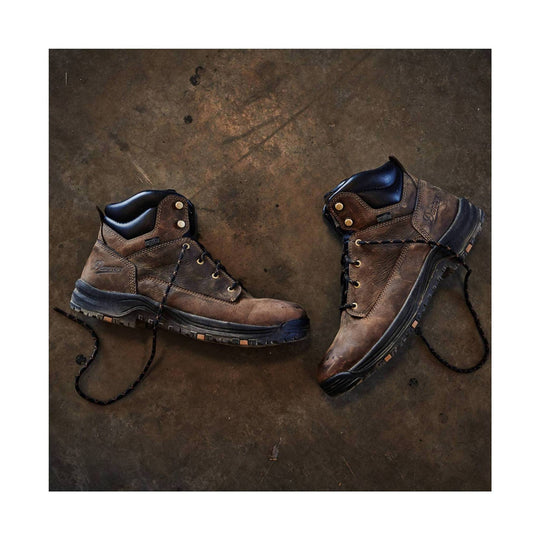 Brown leather work boots with black soles, laces, and padded collars