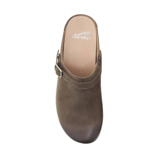 Brown mule clog with a buckle strap and visible Dansko logo on the insole