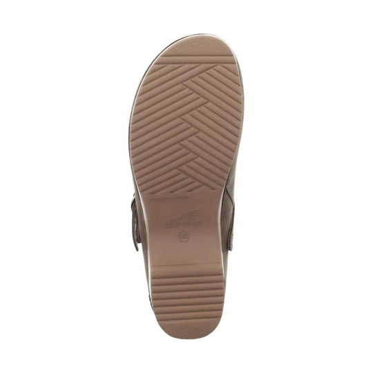 Brown wedge clog sole with herringbone tread and Dansko logo on the heel