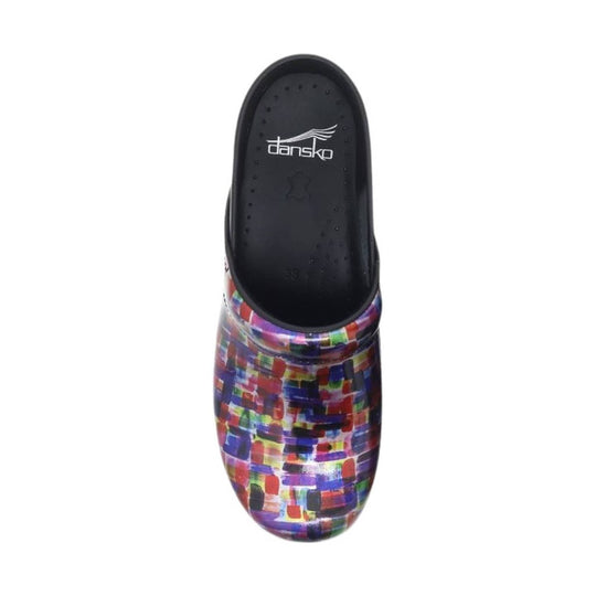 Black clog with a multicolor block-pattern upper and visible Dansko insole branding