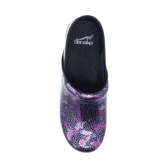 Black clog with purple floral print and visible Dansko logo on the footbed