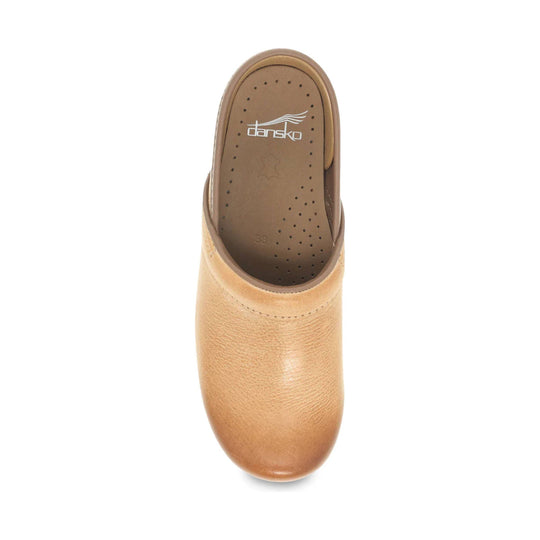 Top view of a tan leather clog with perforated insole and visible Dansko logo