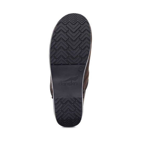 Black outsole of a clog shoe with chevron tread and Dansko logo