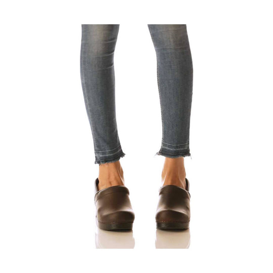 Dark brown leather clogs worn with cuffed jeans, shown from the back