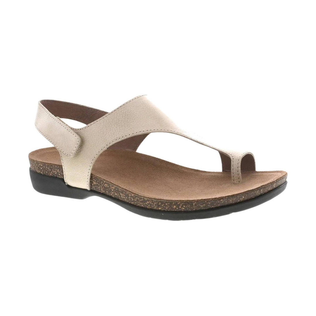 Beige leather wedge sandal with toe loop, ankle strap, and cork-textured sole