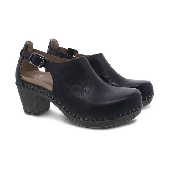 Black leather open-back clog heels with ankle strap, chunky block heel, and studded platform edge