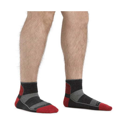 Black and red ankle athletic socks worn on a person's feet and lower legs