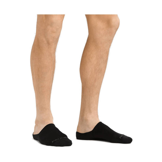 Black no-show socks worn on a model's feet