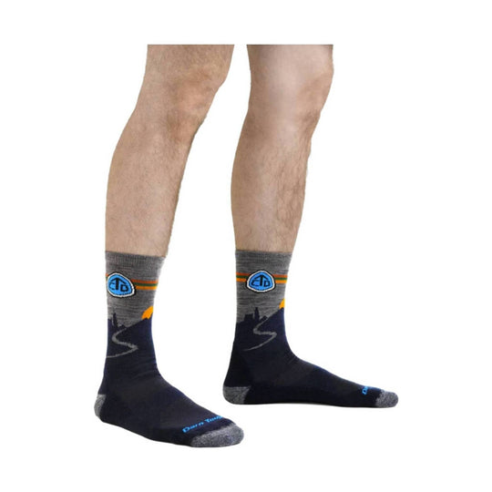 Pair of black and gray hiking socks with blue logo and orange stripes