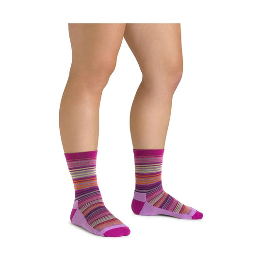 Striped magenta and purple crew hiking socks on a model's lower legs