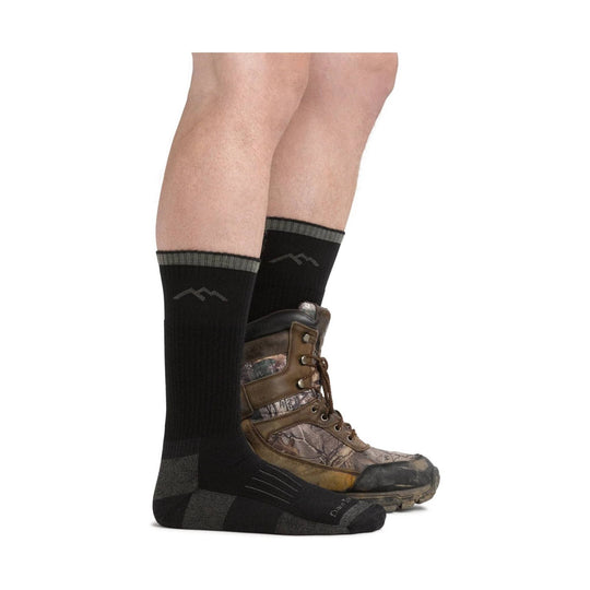 Black mid-calf boot socks worn with camouflage hiking boots