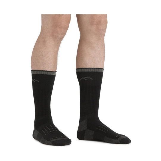 Black over-the-calf socks with gray cuffs on a model's legs