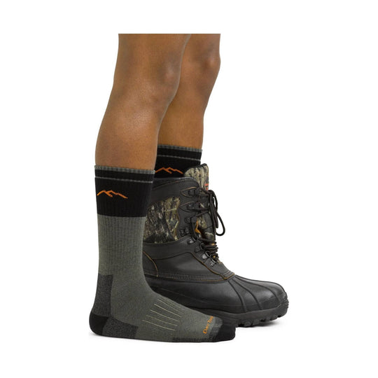 Gray and black hiking sock worn with a camouflage hunting boot