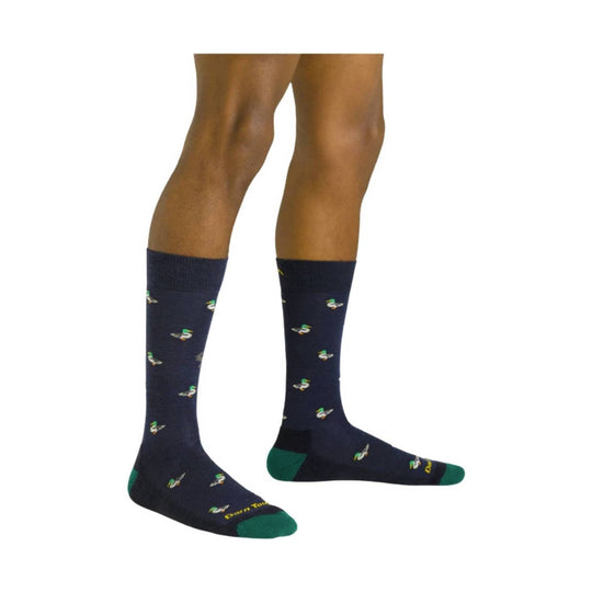 Dark crew socks with small duck pattern and green toe, heel, and cuff accents on a model's legs