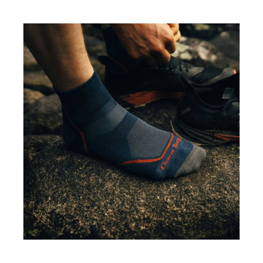 Blue and gray ankle sock with orange trim and visible Darn Tough text