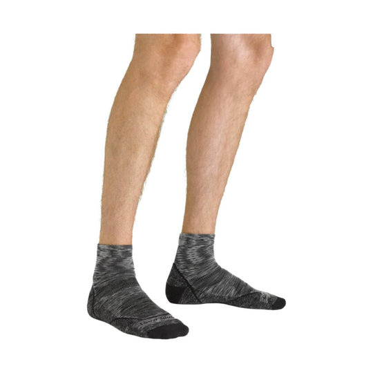 Pair of dark gray ankle socks with heathered knit pattern, shown on legs