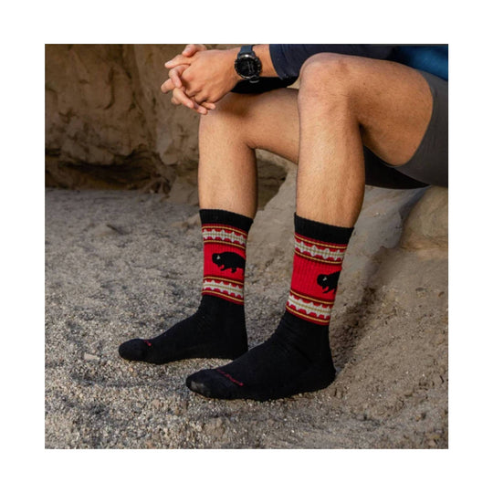 Black crew hiking socks with red patterned cuffs and a bear motif