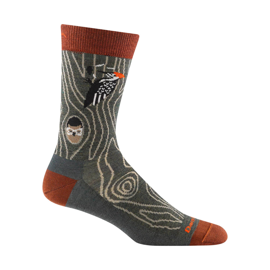 Mid-calf sock with dark forest pattern, rust-colored cuff and toe, and small face and bird graphics