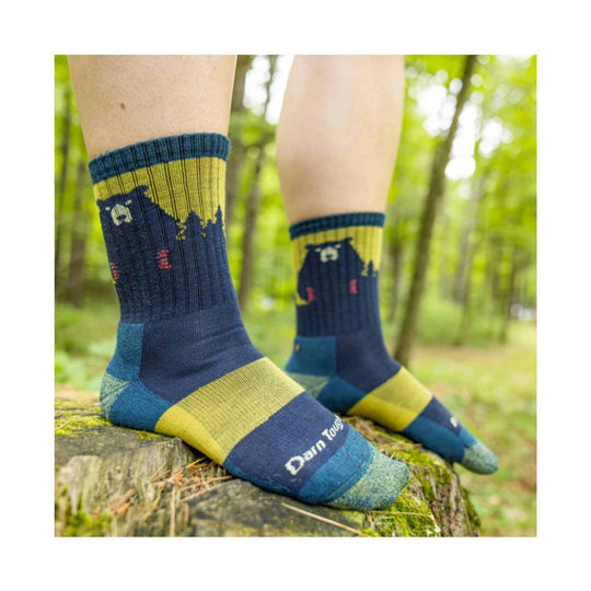 Blue and yellow bear-pattern crew socks worn outdoors