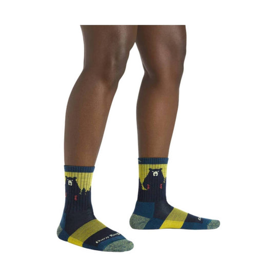 Pair of dark teal crew socks with yellow stripes and bear graphics