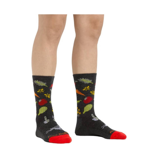 Black crew socks with colorful vegetables and bees, shown on a model from calf to toe