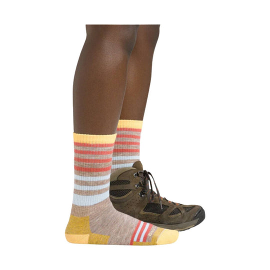 Striped crew socks with yellow toes and heels worn with brown hiking boots