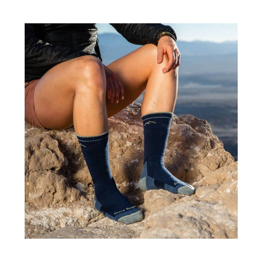 Navy crew hiking socks with gray heels and toes, worn with hiking shoes on rocky terrain