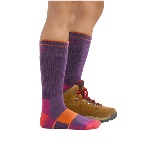 Purple and orange knee-high hiking socks worn with brown hiking boots
