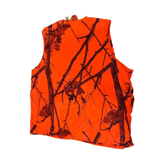 Bright orange sleeveless vest with dark branch-and-leaf camouflage print