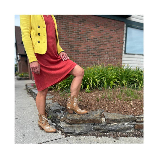Tan embroidered Western ankle boots with pointed toes and stacked heels