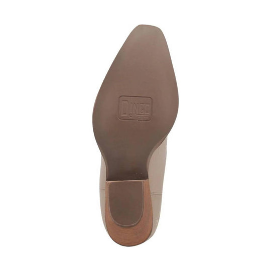 Tan leather boot outsole with a stacked heel and branded sole stamp