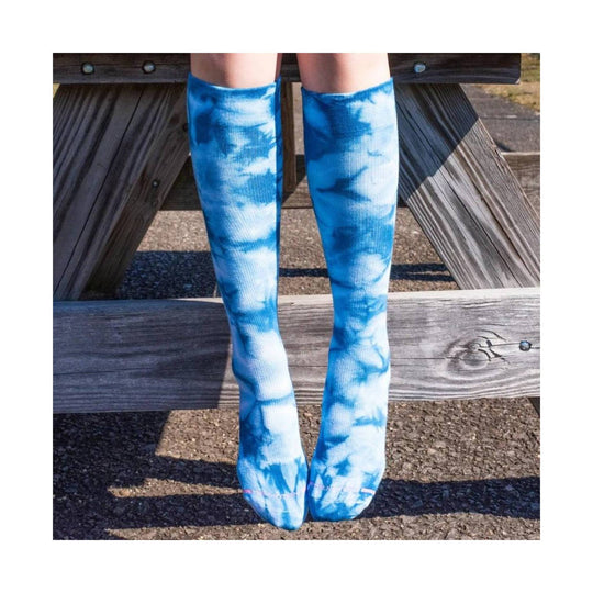 Blue-and-white tie-dye knee-high socks worn on legs, shown with toes pointed together