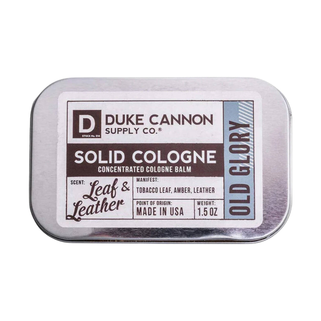 Rectangular metal tin of solid cologne balm with a white label and blue side panel