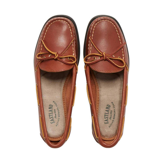 Brown leather boat shoe loafers with contrast stitching, bow laces, and side cutouts, top view