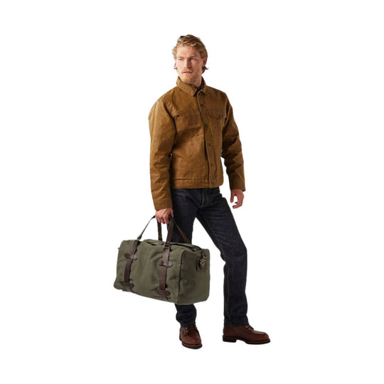 Olive canvas duffel bag with brown leather straps and handles