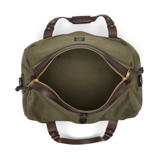 Olive canvas duffle bag with brown leather handles and brass zippers, shown open