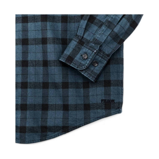 Blue-and-black plaid button-up shirt cuff with buttons and curved hem