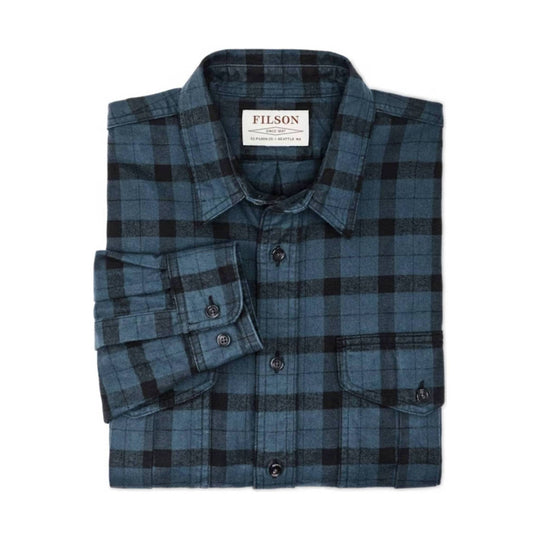Folded blue and black plaid button-up shirt with a collar and chest pocket
