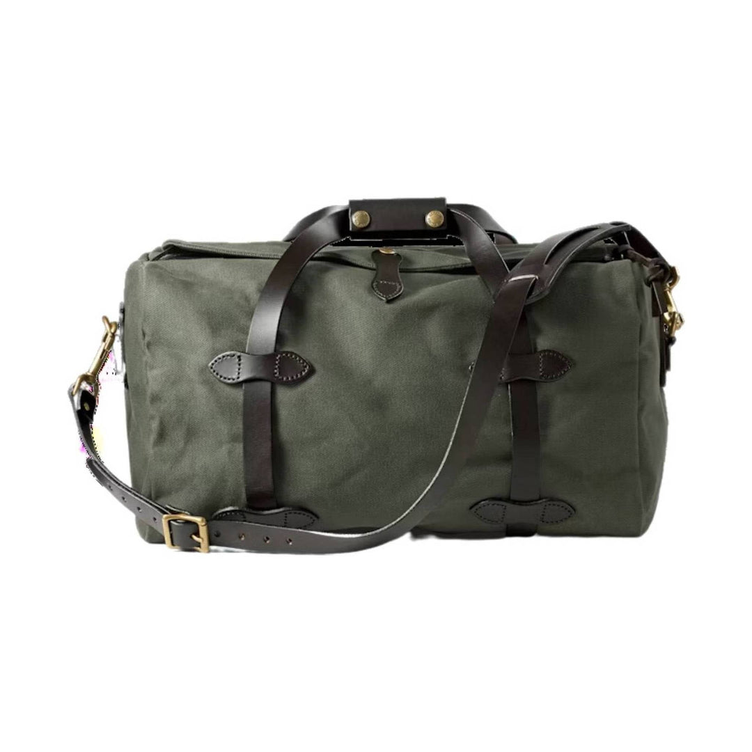 Olive canvas duffel bag with dark leather straps and brass hardware