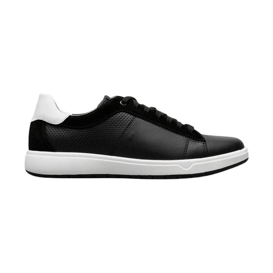 Black low-top sneaker with white heel tab and white sole, shown in side view