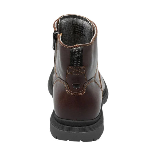 Brown leather ankle boot with side zipper and thick black lug sole, shown from the back