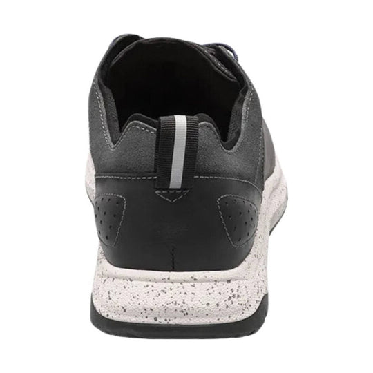 Gray and black sneaker shown from the back with a speckled white sole and heel pull tab