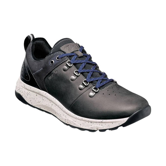 Black low-top hiking sneaker with blue laces, side eyelets, and a speckled white midsole