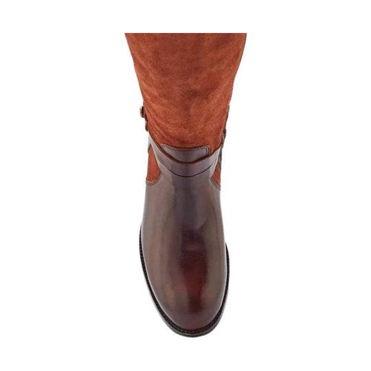 Brown tall leather boot with a rounded toe and decorative ankle strap